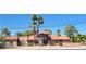 Charming two-story home with terracotta roof, well-maintained landscaping, and mature palm trees at 5820 W Desert Inn Rd, Las Vegas, NV 89146