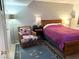 A comfortable bedroom with a large bed, neutral walls, and a cozy seating area at 625 S Royal Crest Cir # 2, Las Vegas, NV 89169