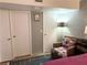 Corner of a bedroom featuring a stylish chair, closet doors and ample lighting at 625 S Royal Crest Cir # 2, Las Vegas, NV 89169