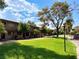 Two-story apartment building with balconies, lush lawn, and mature trees at 625 S Royal Crest Cir # 2, Las Vegas, NV 89169