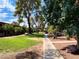 Well-manicured community grounds featuring green grass, mature trees and a walking path at 625 S Royal Crest Cir # 2, Las Vegas, NV 89169
