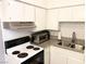 Close-up of the kitchen area showing sleek appliances, granite countertops and white tiled backsplash at 625 S Royal Crest Cir # 2, Las Vegas, NV 89169