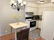Compact kitchen featuring white cabinetry, granite countertops, and a stainless steel oven range at 625 S Royal Crest Cir # 2, Las Vegas, NV 89169