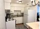 A compact kitchen featuring white cabinetry, granite countertops and modern appliances at 625 S Royal Crest Cir # 2, Las Vegas, NV 89169