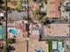 Aerial view showcases a property with a pool, tennis court, and multiple buildings with terracotta roofs at 6545 Laredo St, Las Vegas, NV 89146