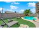 Backyard featuring a swimming pool, lounge chairs and an artificial turf with blue skies at 6611 Ellerhurst Dr, Las Vegas, NV 89103
