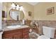 Stylish half bathroom featuring stone accent wall, granite countertop, and modern fixtures at 6611 Ellerhurst Dr, Las Vegas, NV 89103