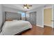 Modern bedroom featuring hardwood floors, a ceiling fan, and a grey headboard bed near the closet at 6611 Ellerhurst Dr, Las Vegas, NV 89103