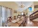 Elegant dining room with chandelier and large windows, open to additional living spaces at 6611 Ellerhurst Dr, Las Vegas, NV 89103