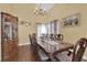 Formal dining room with ornate wood table, chairs, china cabinet, and chandelier lighting at 6611 Ellerhurst Dr, Las Vegas, NV 89103