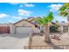 Inviting home featuring low-maintenance desert landscaping, a two-car garage, and a quaint front yard at 6611 Ellerhurst Dr, Las Vegas, NV 89103
