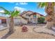 Attractive house with desert landscaping, a two-car garage, and a unique decorative wagon wheel accent at 6611 Ellerhurst Dr, Las Vegas, NV 89103