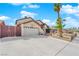 Well-maintained house with a two-car garage, low-maintenance landscaping, and mature palm trees at 6611 Ellerhurst Dr, Las Vegas, NV 89103