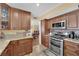 Eat-in kitchen featuring stainless steel oven, granite counters and traditional wood cabinets at 6611 Ellerhurst Dr, Las Vegas, NV 89103