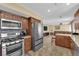 Open-concept kitchen with stainless steel appliances and eat-in breakfast bar at 6611 Ellerhurst Dr, Las Vegas, NV 89103