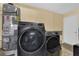 Laundry room featuring Samsung washer/dryer, water heater, and tile floors at 6611 Ellerhurst Dr, Las Vegas, NV 89103