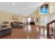 Bright and airy living room with hardwood floors, high ceilings, a piano, and large windows at 6611 Ellerhurst Dr, Las Vegas, NV 89103