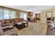 Open concept living space with tile floors, a large sectional sofa, and a view of the kitchen at 6611 Ellerhurst Dr, Las Vegas, NV 89103