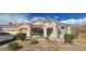 Charming single-story home with stucco exterior, tile roof, landscaped front yard, and covered entry at 6744 Universal Ave, Las Vegas, NV 89142