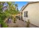 Lovely backyard featuring gravel landscaping, a covered patio, flowering plants, and a tranquil outdoor space at 7172 Painted Paradise St, Las Vegas, NV 89131
