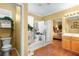 Bright bathroom with a shower-over-tub, indoor plants, and seamless access to the main bedroom at 7172 Painted Paradise St, Las Vegas, NV 89131