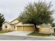 Traditional single-story home with three-car garage and mature landscaping enhancing curb appeal at 7172 Painted Paradise St, Las Vegas, NV 89131