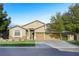 Single story home featuring three-car garage, desert landscaping and stone accents at 7172 Painted Paradise St, Las Vegas, NV 89131