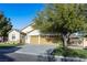 This home features a three-car garage, a manicured lawn, mature landscaping, and a gated entrance at 7172 Painted Paradise St, Las Vegas, NV 89131