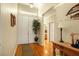 Inviting foyer with hardwood floors, plant, and decoratively painted walls at 7172 Painted Paradise St, Las Vegas, NV 89131