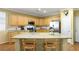 Well-lit kitchen with stainless steel appliances, granite countertops, and an island with seating at 7172 Painted Paradise St, Las Vegas, NV 89131