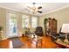 Bright living room with hardwood floors, ceiling fan, and comfortable leather furniture at 7172 Painted Paradise St, Las Vegas, NV 89131