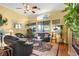 Bright living room with large windows, hardwood floors, and elegant decor at 7172 Painted Paradise St, Las Vegas, NV 89131