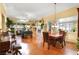 Open-concept living room and dining area with abundant natural light and hardwood floors at 7172 Painted Paradise St, Las Vegas, NV 89131