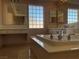Bright bathroom featuring a soaking tub, marble countertops, and large window at 8122 Delphi Ct, Las Vegas, NV 89117