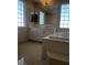 Bright bathroom featuring a soaking tub, marble countertops, and tiled floor at 8122 Delphi Ct, Las Vegas, NV 89117