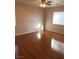 Bright bedroom with light hardwood flooring, ceiling fan, and a large window at 8122 Delphi Ct, Las Vegas, NV 89117