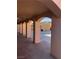 Spacious covered patio with supporting columns, providing shade and access to a backyard storage shed at 8122 Delphi Ct, Las Vegas, NV 89117