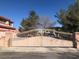 Wrought iron security gate and lush landscaping provide enhanced privacy at 8122 Delphi Ct, Las Vegas, NV 89117