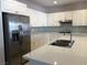 Renovated kitchen featuring a center island, stainless steel appliances, and stylish backsplash at 8122 Delphi Ct, Las Vegas, NV 89117