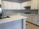 Bright kitchen features white cabinets, stainless steel appliances, and quartz countertops at 8122 Delphi Ct, Las Vegas, NV 89117