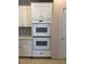 All white kitchen features white cabinets and stainless steel double oven at 8122 Delphi Ct, Las Vegas, NV 89117