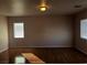 Bright living room with hardwood floors and two windows at 8122 Delphi Ct, Las Vegas, NV 89117