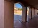 Arched pillars give a view of the back yard from the covered patio at 8122 Delphi Ct, Las Vegas, NV 89117