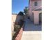 Side yard view with a well-maintained walkway leading to a gate, complemented by a garden area at 8122 Delphi Ct, Las Vegas, NV 89117
