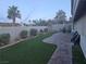 Backyard with seating area, manicured lawn, and desert landscaping at 824 Holly Lake Way, Henderson, NV 89002