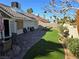 Backyard featuring turf, desert landscaping, and patio with seating at 824 Holly Lake Way, Henderson, NV 89002
