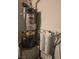 Image shows a hot water tank and water filtration system in the basement at 824 Holly Lake Way, Henderson, NV 89002