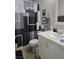 Bathroom features a modern shower curtain, toilet, sink, and a tiled floor at 824 Holly Lake Way, Henderson, NV 89002