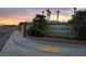 Palm Canyon community entrance sign surrounded by lush landscaping and palm trees at sunset at 824 Holly Lake Way, Henderson, NV 89002