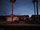 Charming single-story home with a well-maintained front yard and a two-car garage at dusk at 824 Holly Lake Way, Henderson, NV 89002